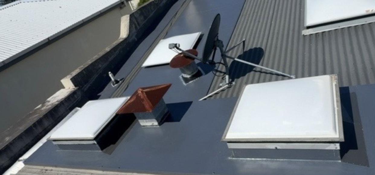 Close-up of terracotta roof tile and gutter detail on a Vulcon restoration job