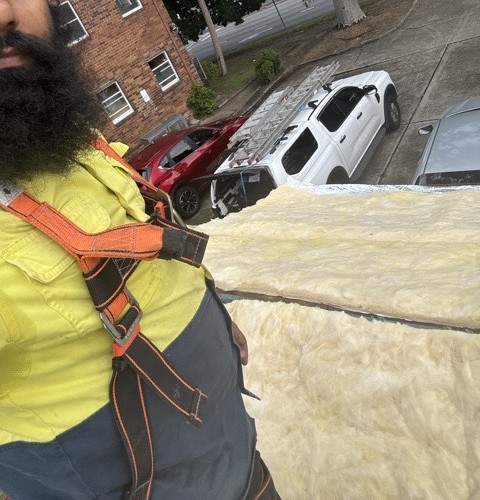 Vulcon crew member in full harness on a roof restoration job