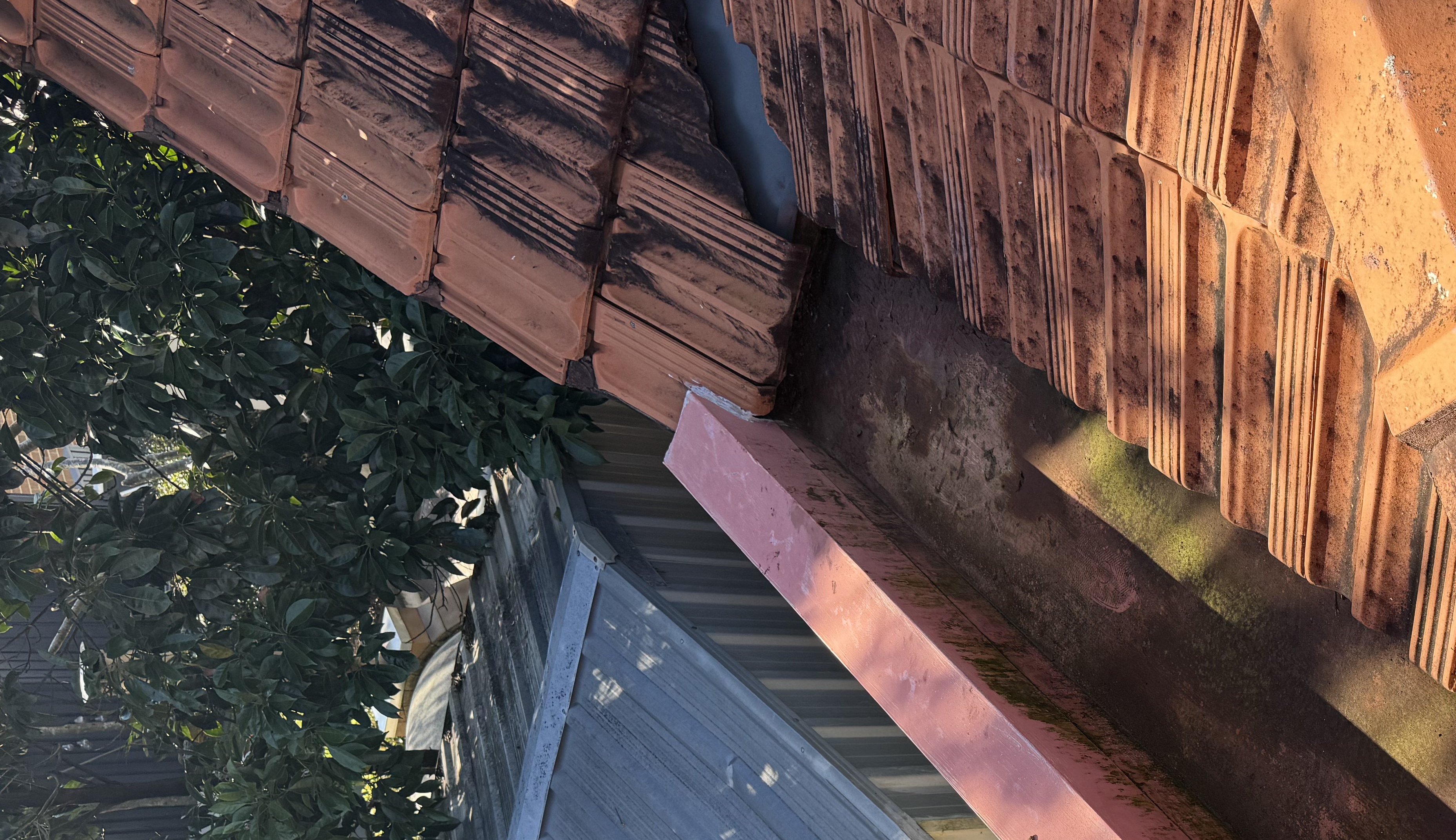Gutter and flashing repair detail on a tile roof